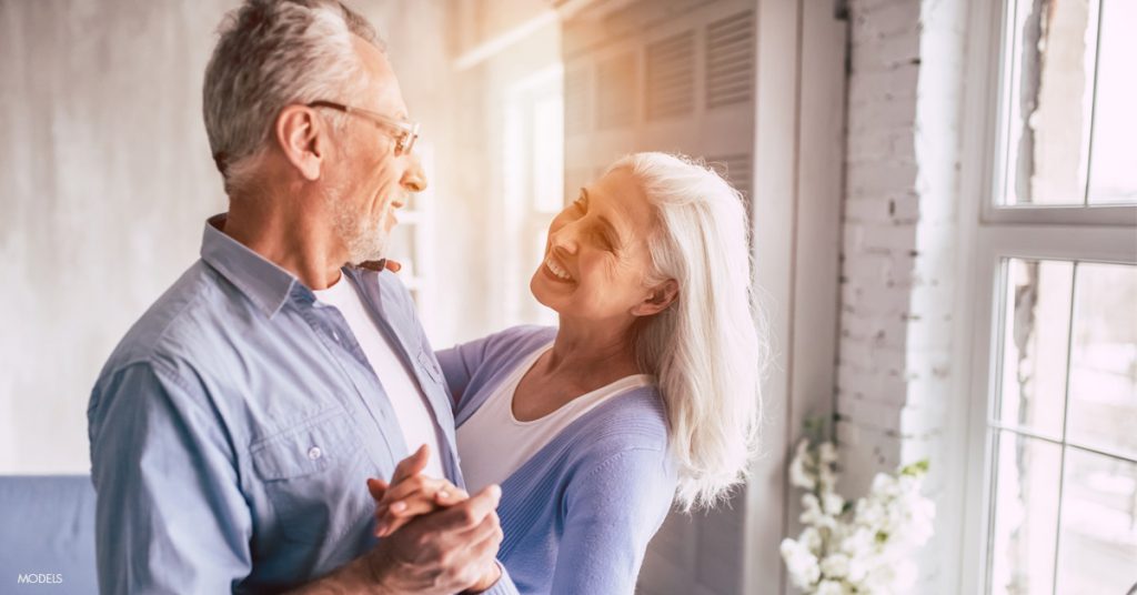 Older husband and wife dancing and discussing rhinoplasty