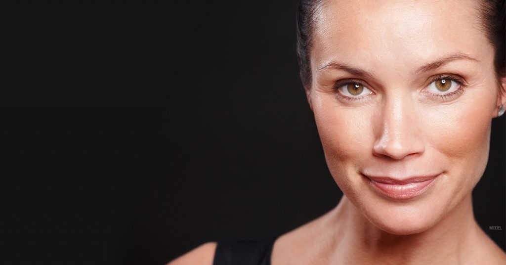 Women smiling after eyelid surgery in Chicago (model).