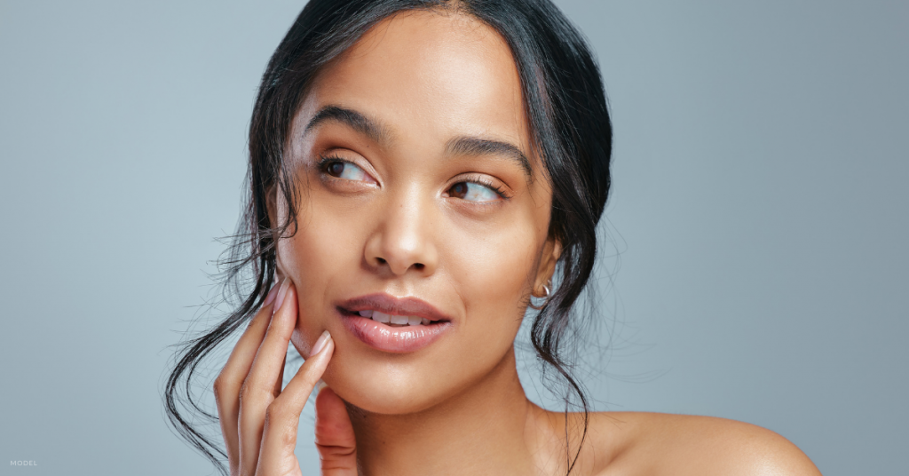 A woman with clear skin looking away from camera (model).