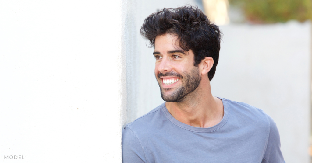 A man with thick hair, looking off into the distance (model)