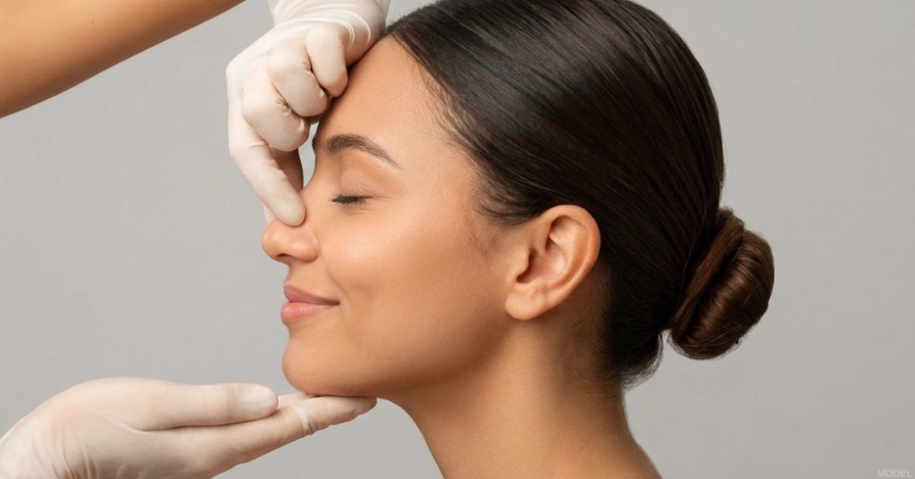 Woman examined before rhinoplasty procedure. (Model)